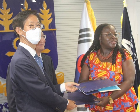    Mr Mooheon Kong (left) Country Director of KOICA to Ghana exchanging the signing of the Record of Discussion with the vice-chancellor of the University of Ghana, Prof. Nana Aba Amfo in Accra.